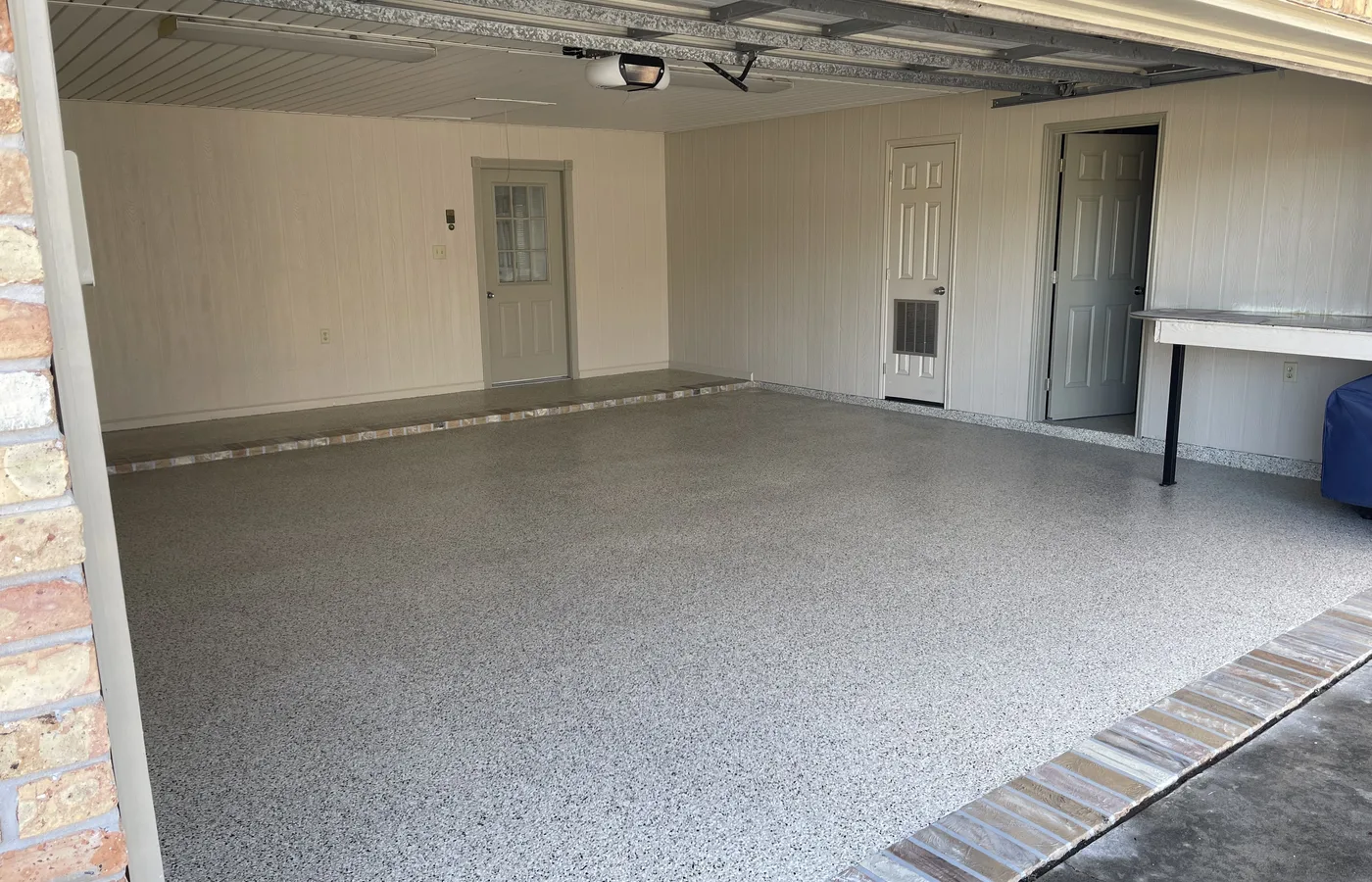 Decorative flake concrete floor in a residential garage.