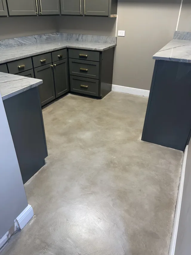 Neutral stained concrete kitchen floor by Decorative Concrete of South Louisiana.
