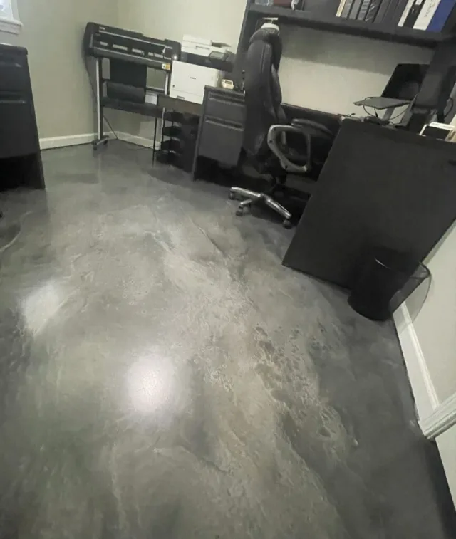 The same metallic office floor with the desk and equipment back in use.