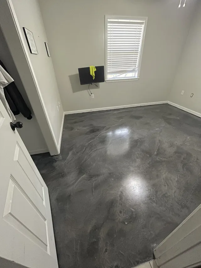 Metallic floor across an office room, seen from the doorway.