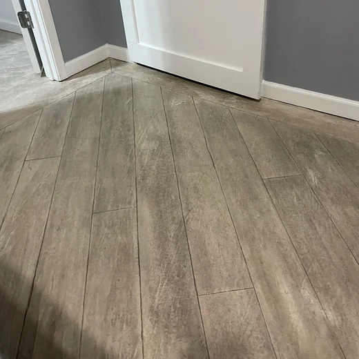 Close view of wood-grain texture in a wood-look decorative concrete overlay.