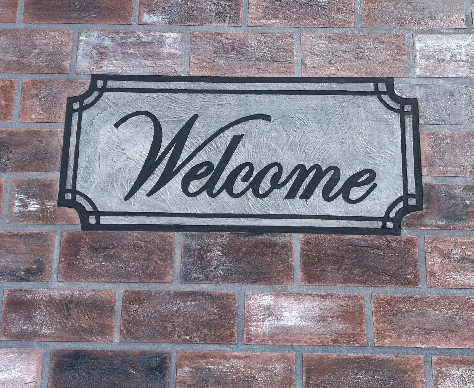 Brick-style decorative concrete overlay with custom inlay detail by DCOSL.