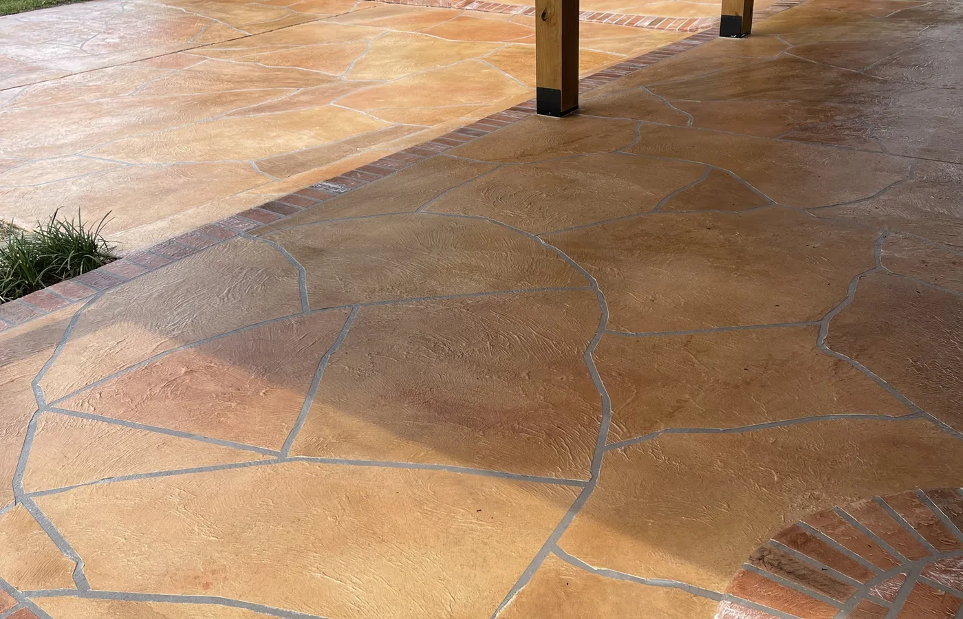 Finished flagstone-style decorative concrete overlay in an outdoor living area.