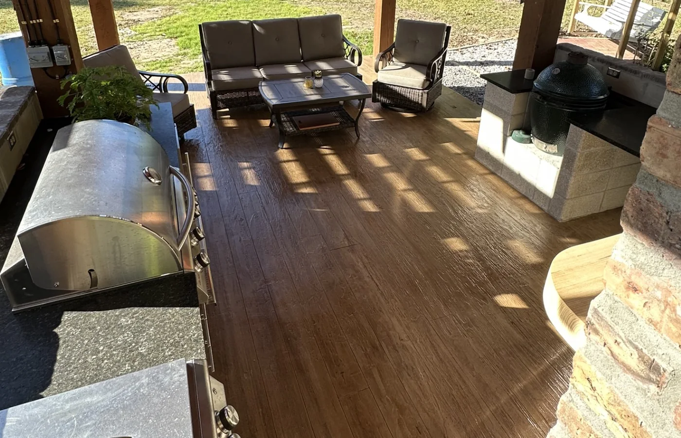 Warm wood-look concrete finish beneath outdoor seating.