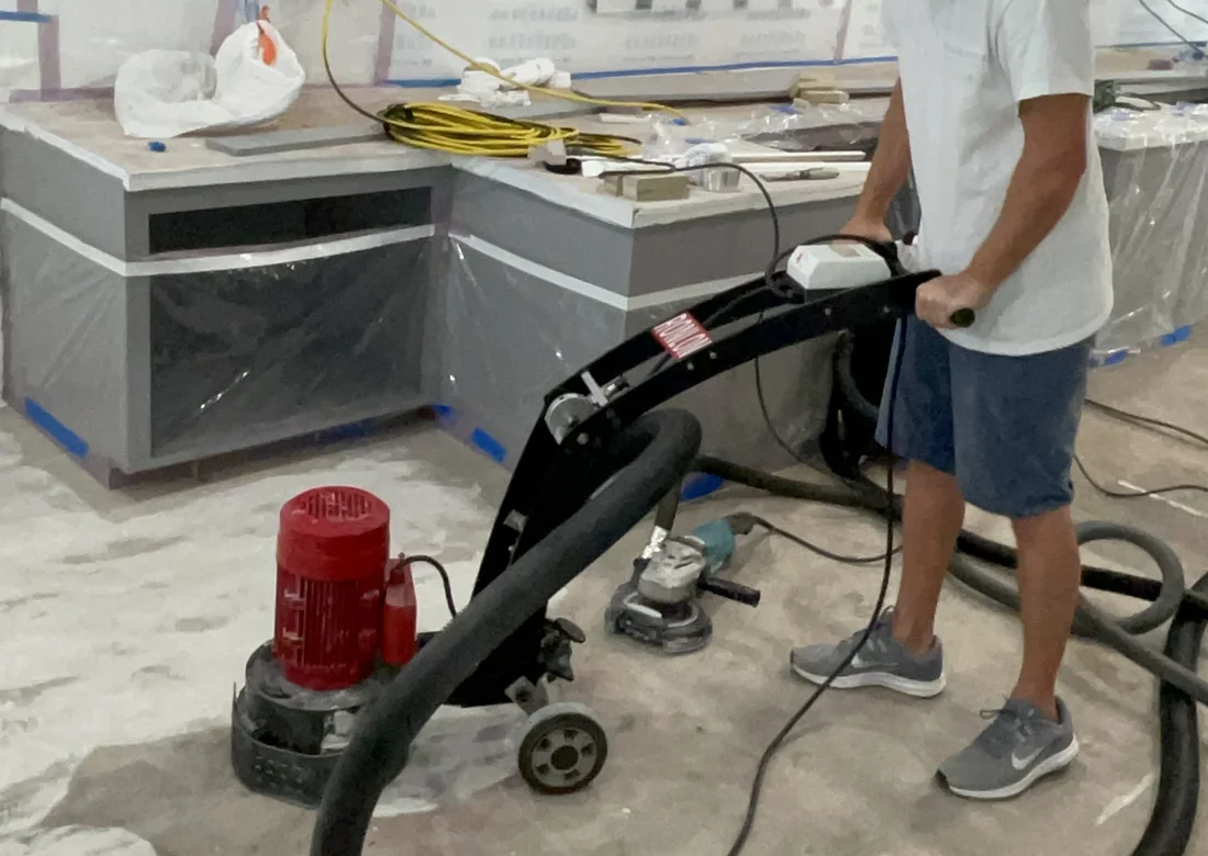 Mechanical concrete floor preparation before finishing.