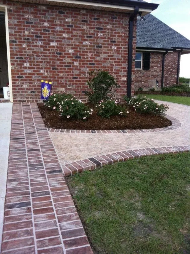 Brick-border garden walkway by Decorative Concrete of South Louisiana.