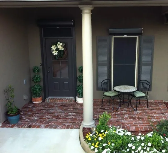 Brick-pattern front porch overlay by Decorative Concrete of South Louisiana.