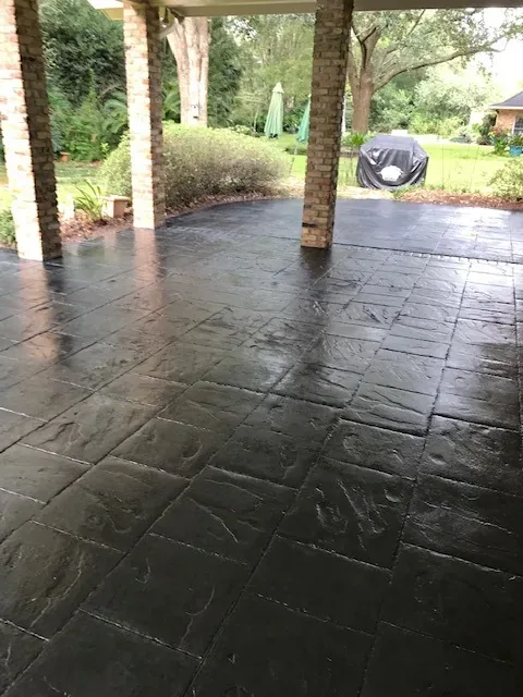 Charcoal slate overlay on a covered patio by Decorative Concrete of South Louisiana.