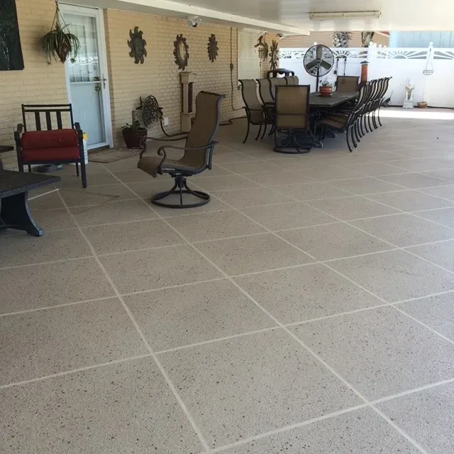 Scored tile overlay on a large covered patio by Decorative Concrete of South Louisiana.