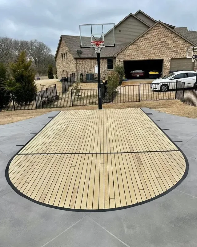 Wood-look basketball court overlay by Decorative Concrete of South Louisiana.