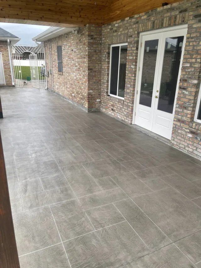 Ashlar slate pattern running the length of the porch along the brick wall.