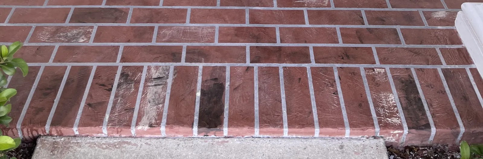 Red brick-pattern surface at the entry edge.