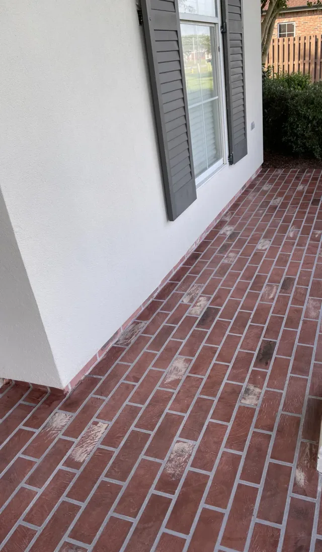Brick-pattern front entry by Decorative Concrete of South Louisiana.