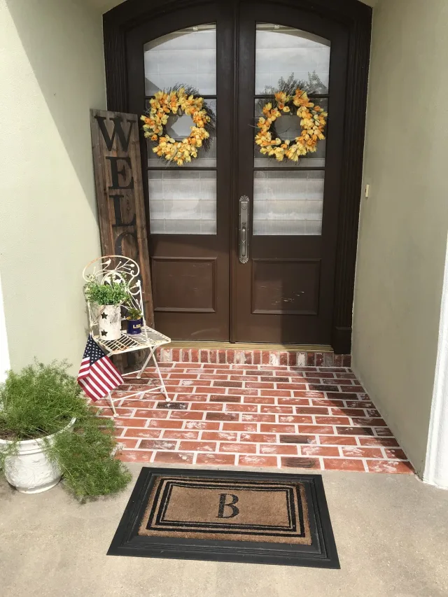 Brick-pattern entry at double doors by Decorative Concrete of South Louisiana.