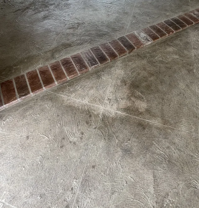 Existing decorative garage floor and brick-pattern border before refurbishment.