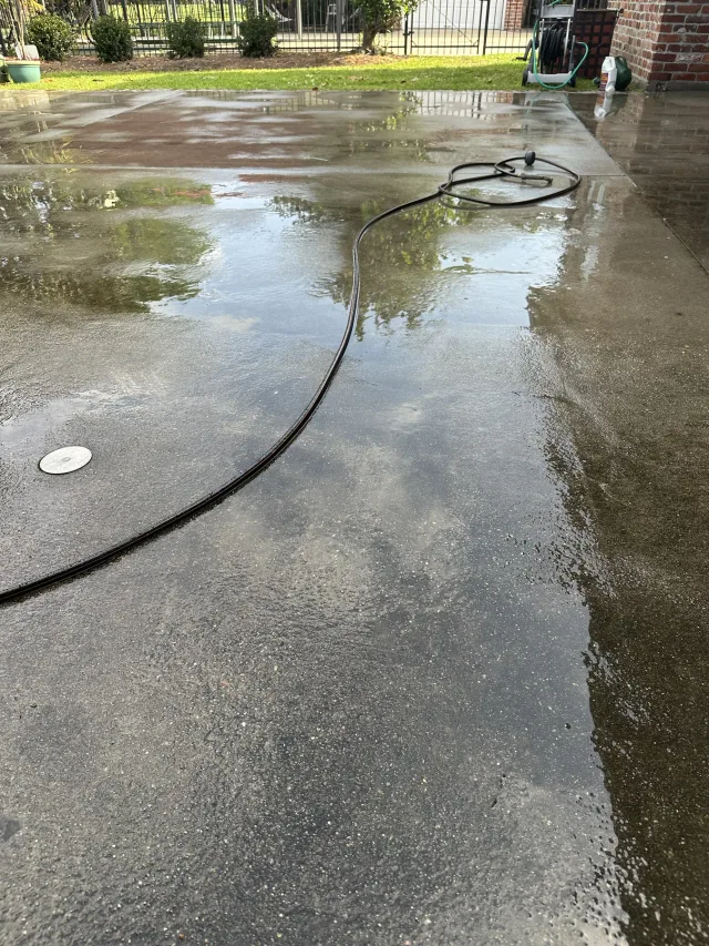Patio being cleaned and prepared before the overlay.