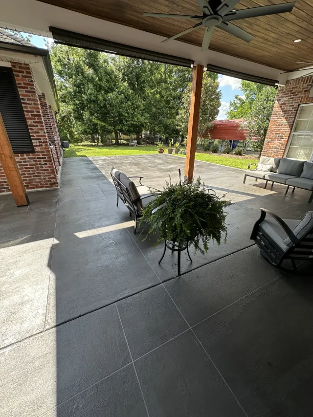 Charcoal large-format ashlar slate patio by Decorative Concrete of South Louisiana.