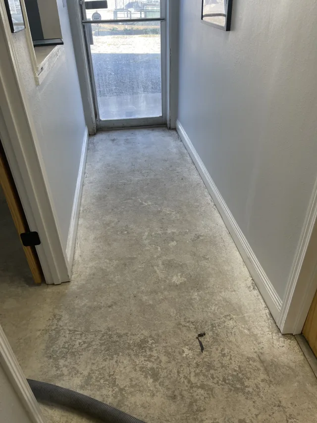 Bare concrete floor in the office entry before the gray flake coating was installed.