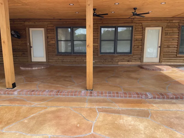 The covered patio finished in the flagstone pattern with a brick border.