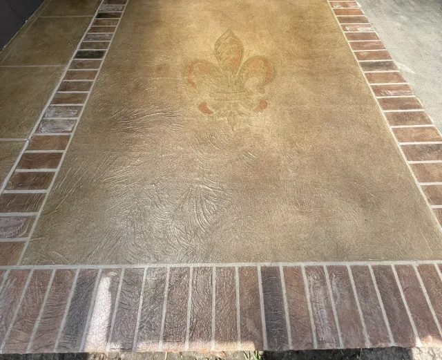 Fleur-de-lis outdoor kitchen floor by Decorative Concrete of South Louisiana.