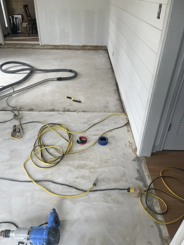 Bare slab being prepared in the living area before staining.