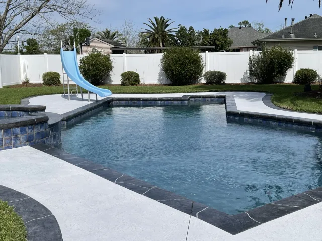 Another view of the same light pool deck beside the pool and slide.