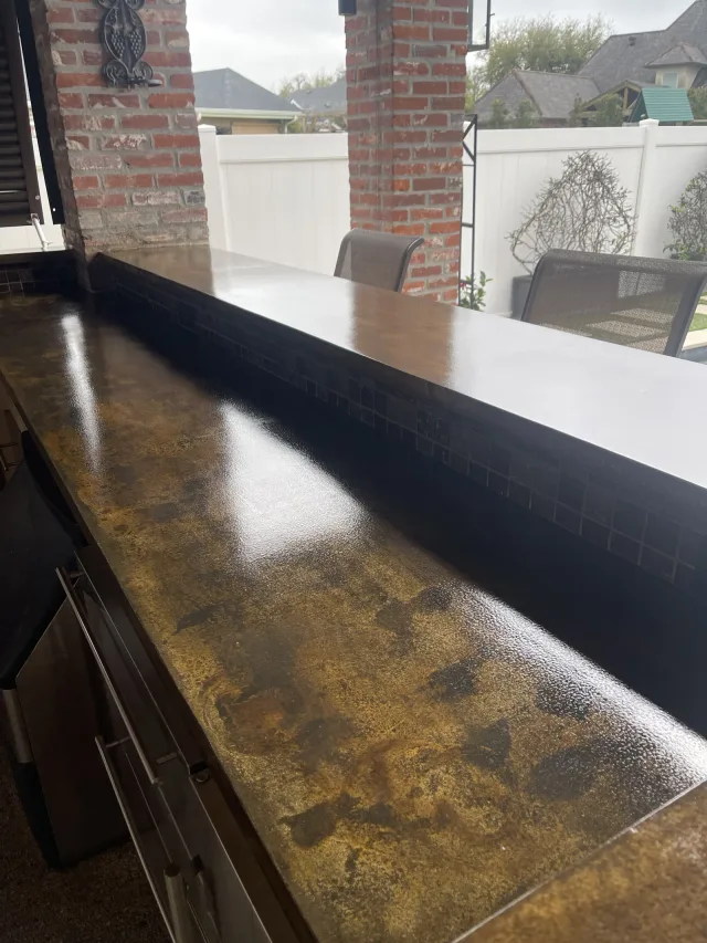 Bronze-toned outdoor kitchen countertops by Decorative Concrete of South Louisiana.