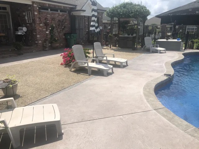 The same pool deck showing the warm border around the pool curve.