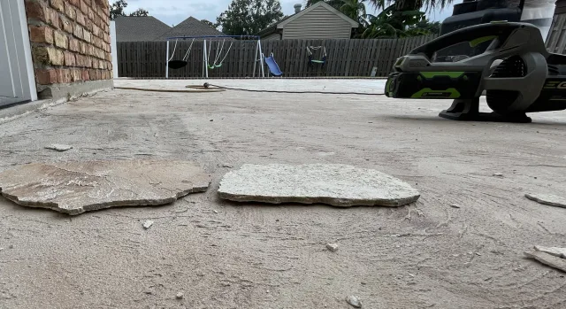 Pieces of the old coating detached from the deck during removal.