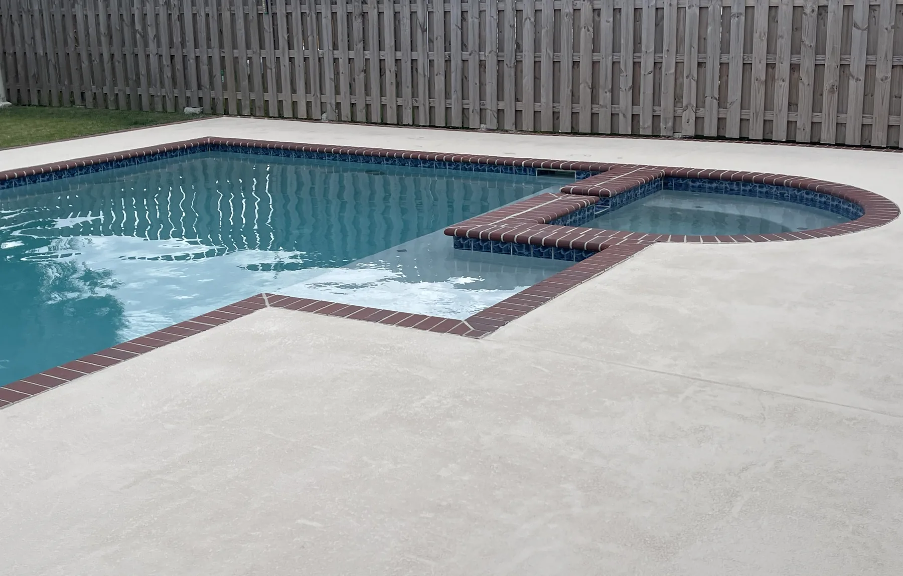 The same pool after its deck was resurfaced with a light decorative finish.