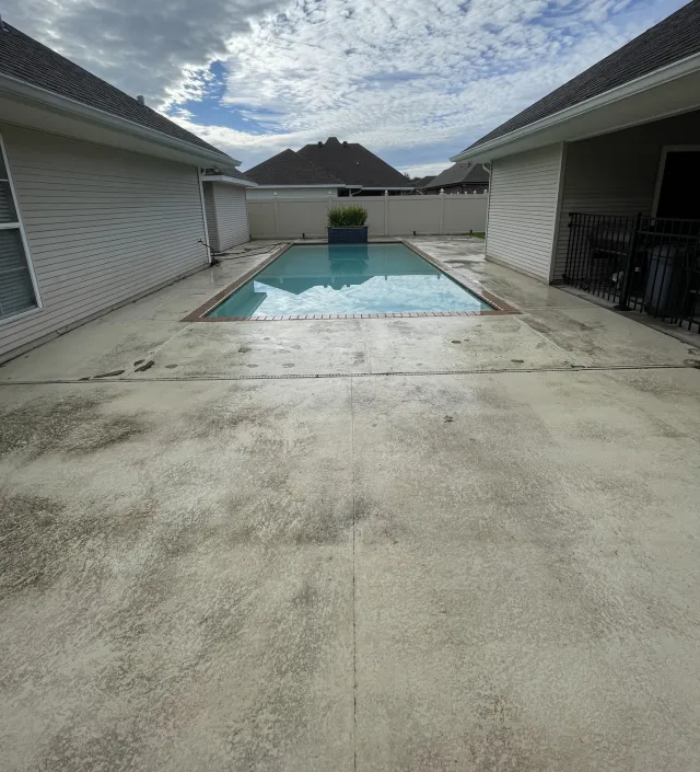 Worn and failing deck surface around the same rectangular pool before removal.