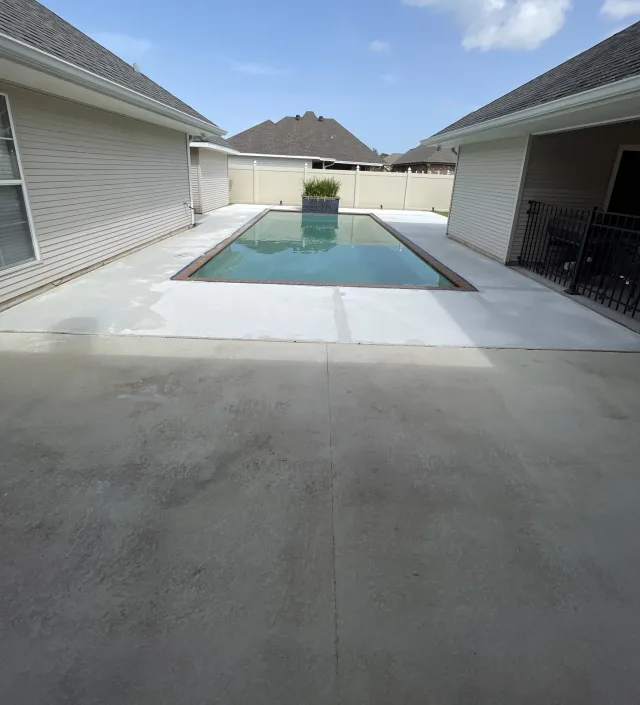 The same pool during resurfacing, with a light new surface beside the darker foreground.