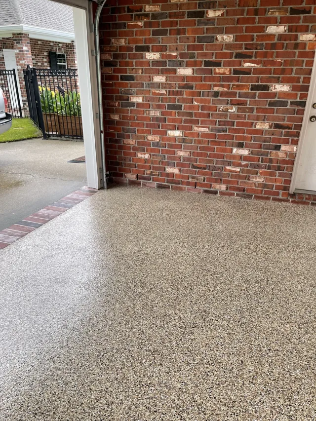 Flake color and red-brick threshold in the same garage.