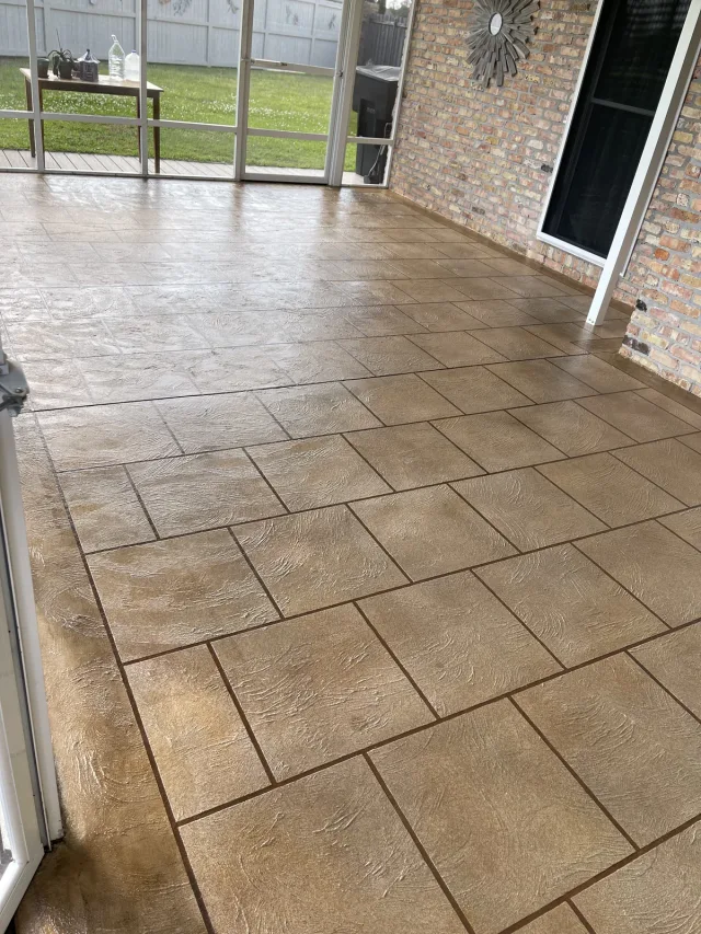 Tan floor in a screened porch by Decorative Concrete of South Louisiana.