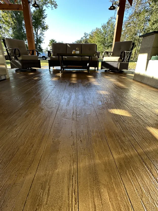 Wood-grain texture and plank layout in the same pavilion floor beside the outdoor dining furniture.